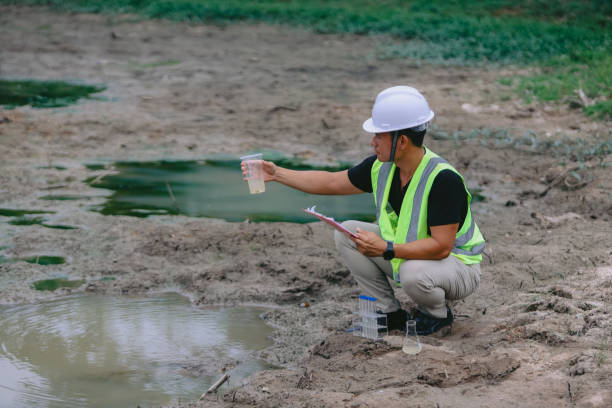 istock Environment Issue concept. Team of Scientists in protective suits and masks took a sample of water for analysis. Environment Issue concept 2152815689