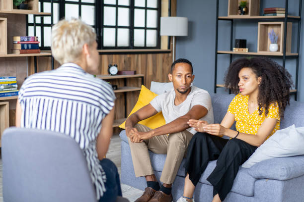 istock Young couple blaming each other in relationship problems at counselor's office 2152815876