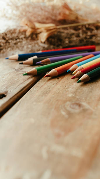 Colored pencils on a wooden desk.