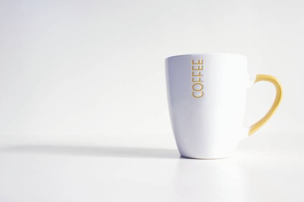 istock white and yellow cup with white background and shadow 2152816492