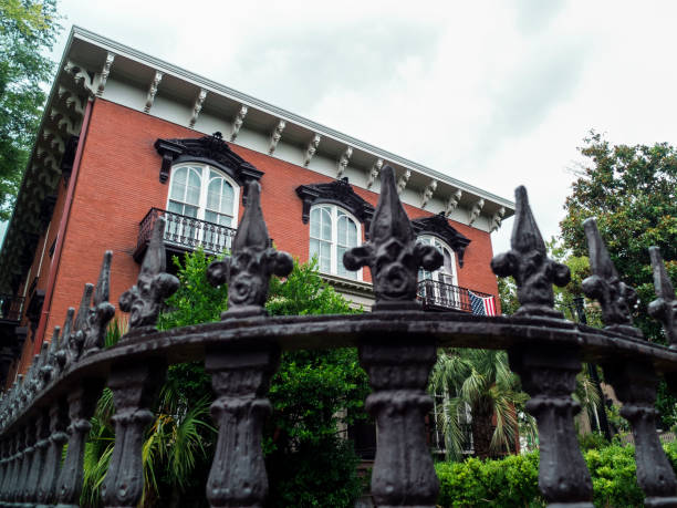 istock Black Iron Gate Surrounding a Frech Victorian Style House 2152819062