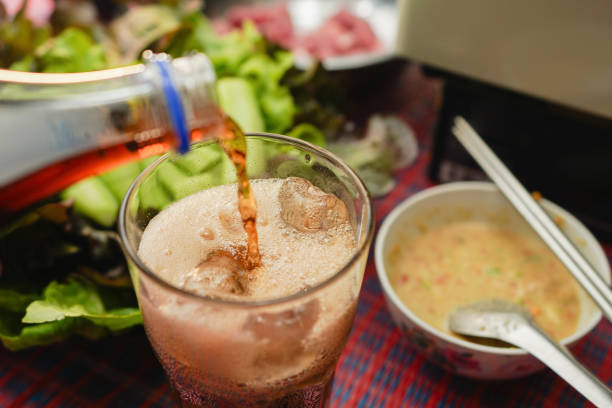 Enjoying refreshing soft drinks poured over ice after savoring a grilled menu