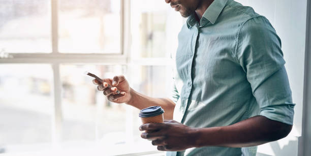 istock Office, hands and man with phone, coffee cup and scroll on social media, email or online chat. Networking, communication and creative professional with smartphone for business connection with drink 2152821940