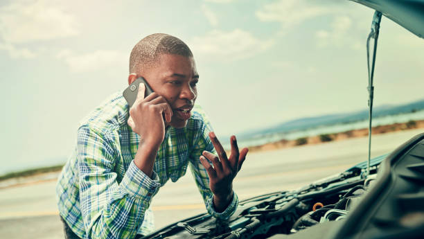 istock Black man, talk and phone call for car problem on road, app and roadside assistance for auto service. Person, battery and power issue with vehicle on street, speaking and conversation for emergency 2152821943