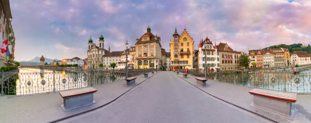 Lucerne at sunrise in Switzerland Panorama Reussbrucke bridge at sunrise with Jesuit Church in Old Town of Lucerne, Switzerland lucerne switzerland stock pictures, royalty-free photos & images