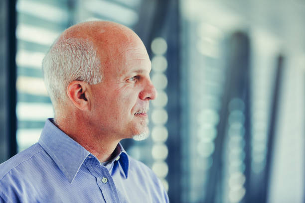 istock Contemplative senior with white hair, modern setting 2152827471