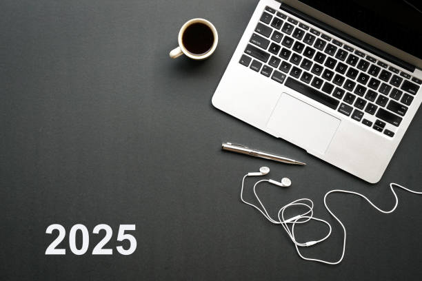 istock 2025, text on black top with computer laptop, earphones and coffee. 2152828293