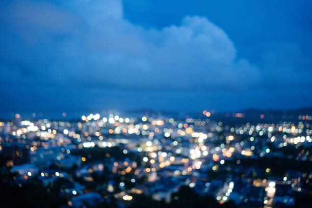 Abstract blur bokeh of night light city with mountain background