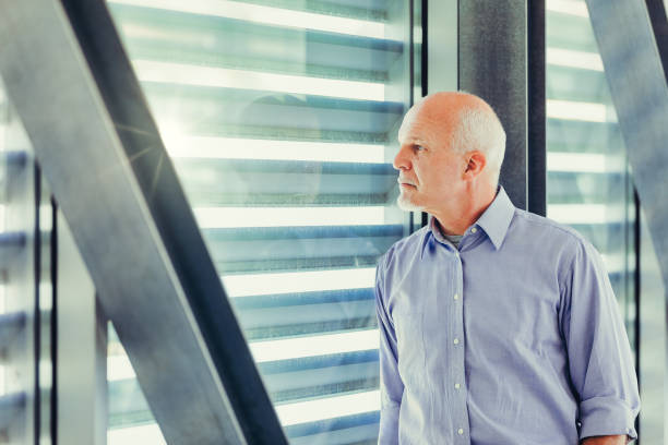 istock Elderly man in blue shirt looks away 2152828636