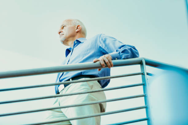 istock Thoughtful senior leans on railing, contemplating future 2152828706