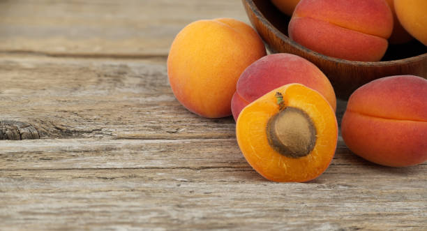 istock Group of fresh apricots isolated on rustic wooden table 2152829100