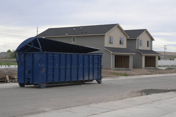 Large Blue Construction Dumpster Large blue construction dumpster in front of new duplex homes under construction. large dumpster stock pictures, royalty-free photos & images
