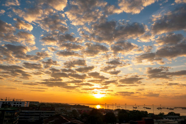 Scenic view dramatic beautiful sunset sky. Natural Sunset Sunrise on meadow silhouette shadow dark land. Vibrant dramatic sky on sunset, dawn, sunrise in Countryside. Landscape Colorful Sky At Sunset