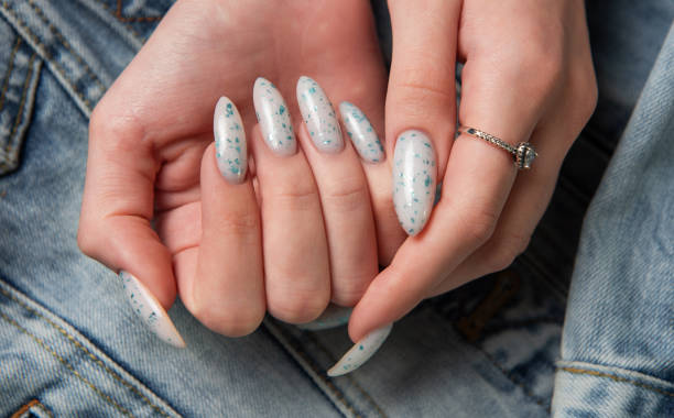 istock Female hands with blue nail design. Blue nail polish manicure. 2152834149