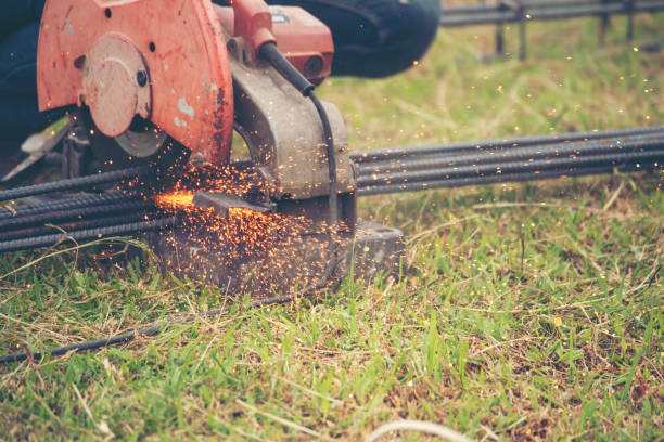 istock Construction Worker hands using Welding machinery iron metal sparking. Men hands wear protective glove Hot flame metal work cutting fire iron workshop. Locksmith use Welding machine cut metal process 2152834382