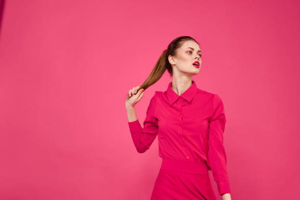 Emotional woman pink shirt bright makeup studio cropped view. High quality photo