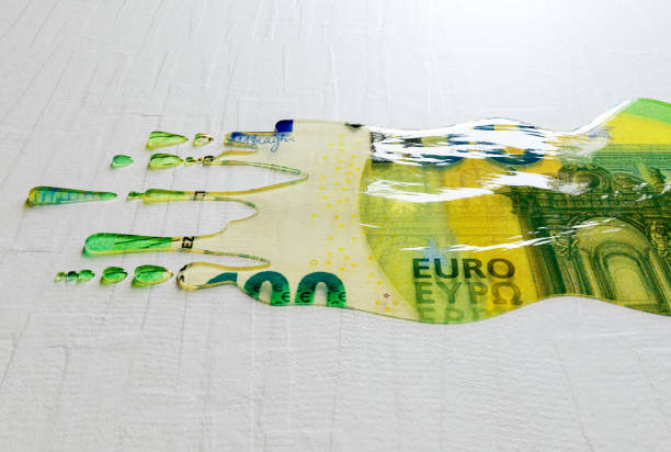 A concept image showing a regular European Euro banknote that is melted and liquified dripping on an white surface background - 3D render