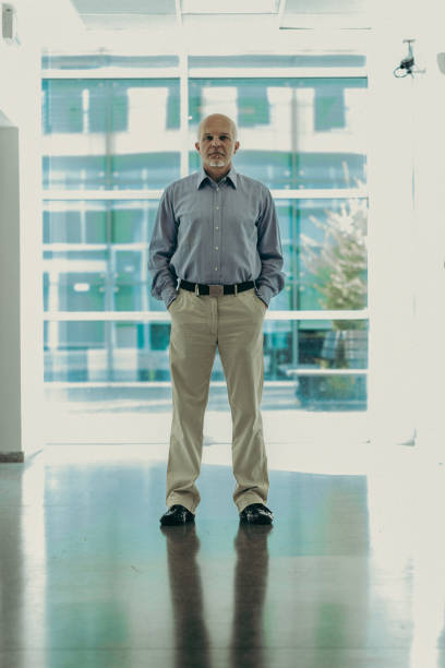 istock Mature businessman stands in bright, modern office 2152837195