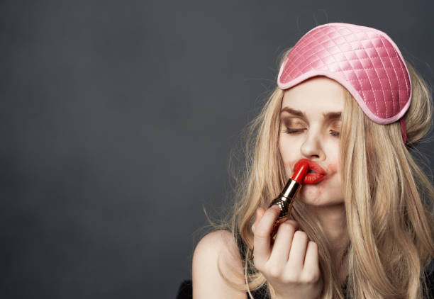 istock blonde with lipstick smears makeup on her face and eye shadow 2152837423