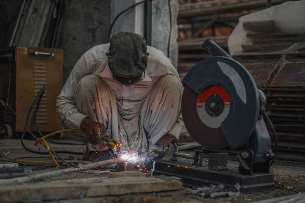 istock Skilled Welder welding metal rods in Workshop 2152838433