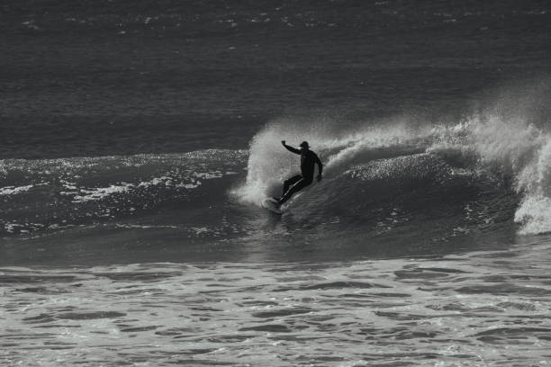 istock A surfer riding a surfing wave, black and white 2152838443