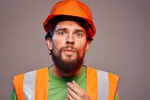 istock Man in orange paint construction security professional gray background 2152840362
