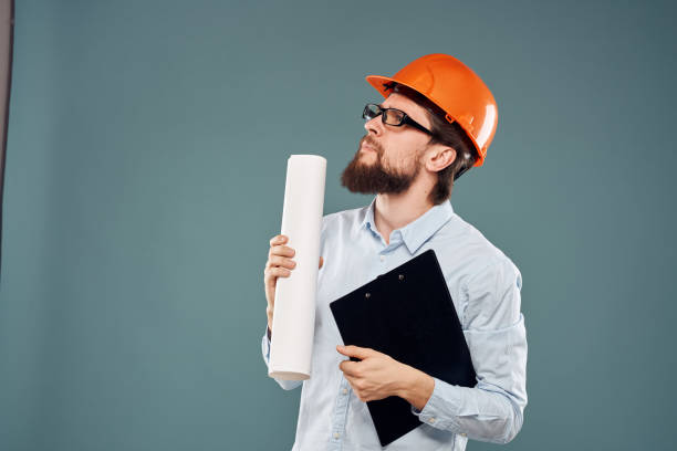 istock A male engineer in an orange hard hat with documents in the hands of construction drawings 2152840580