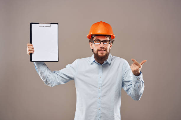 istock Worker man orange hard hat construction industry manual 2152840754