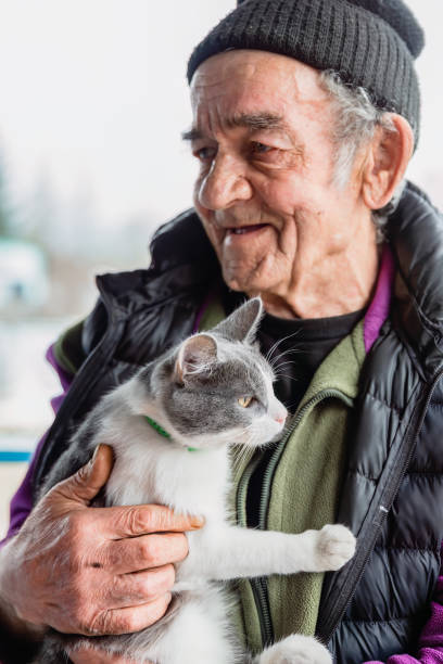 istock Old Russian man holding his cat and smiling 2152841162