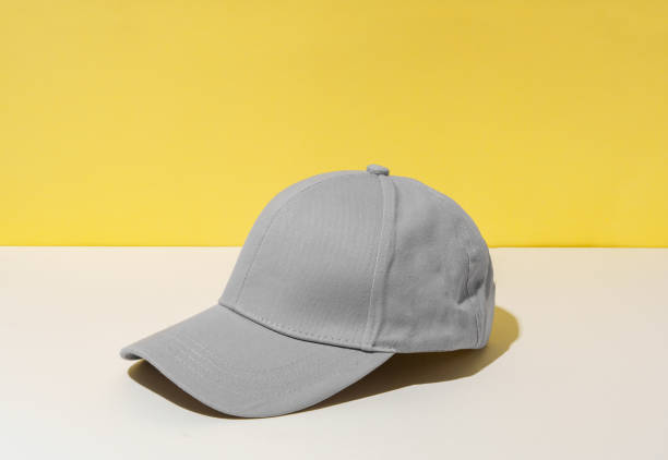 istock Baseball hat against yellow background in studio 2152843481