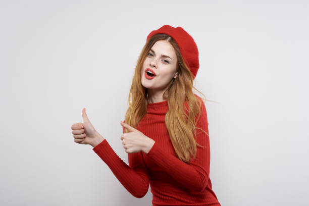 istock cheerful woman hand gesture fun Red lips luxury light background 2152843700