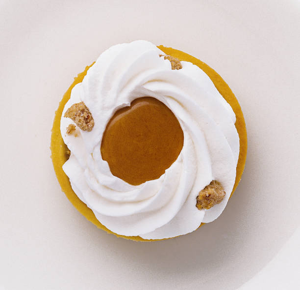 Top view of a lemon tart topped with meringue, elegantly served on a white ceramic plate