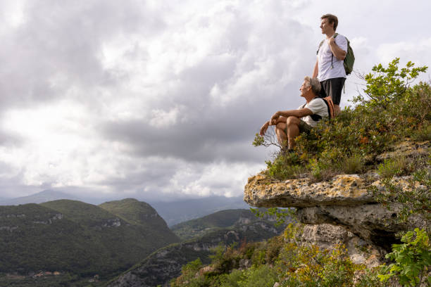 istock Father and son pause on hilltop 2152844227