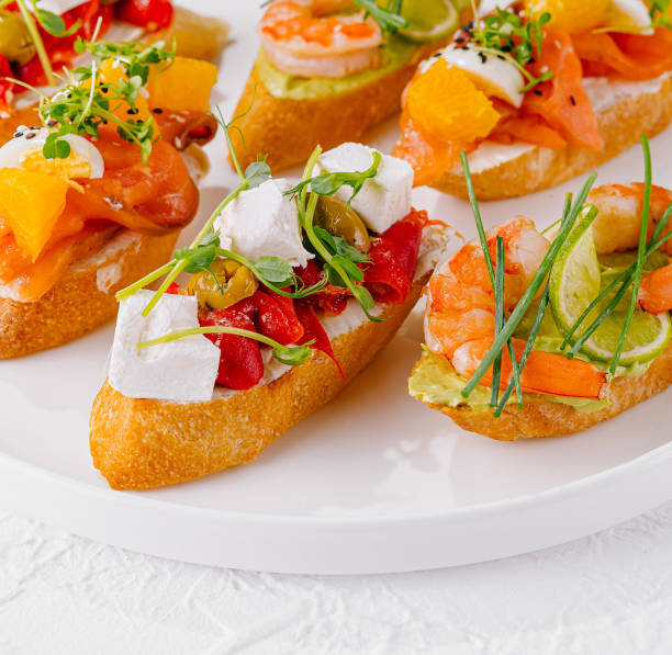 istock Elegant platter of assorted bruschetta with fresh toppings on a white background 2152844632