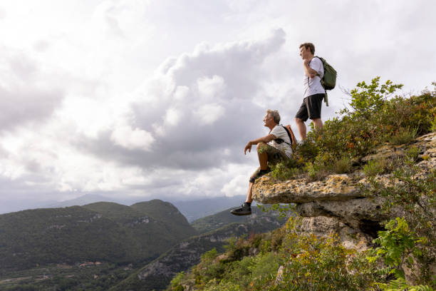istock Father and son pause on hilltop 2152844736