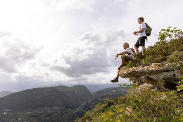 istock Father and son pause on hilltop 2152845173