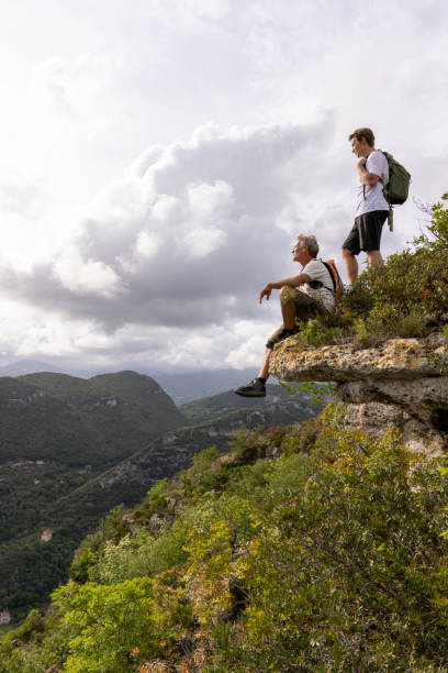 istock Father and son pause on hilltop 2152845395
