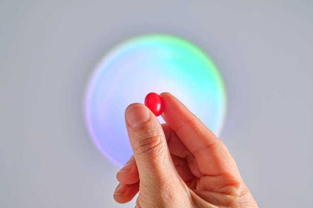 istock A red tablet of a vitamin complex in a hand. 2152845634