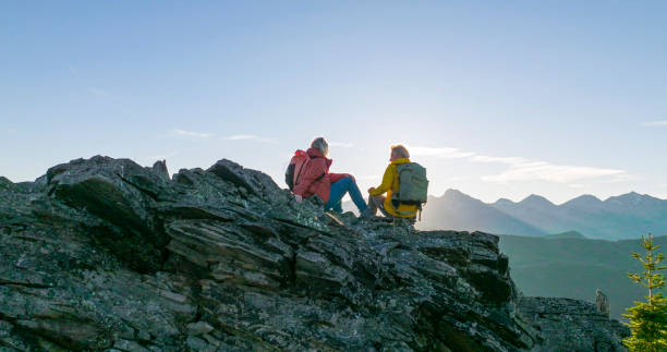istock Senior couple explore mountain top together at sunrise 2152846761