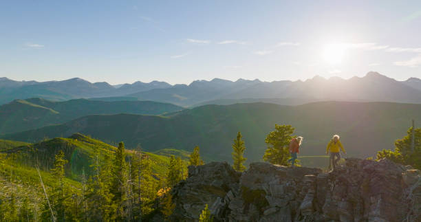 istock Senior couple explore mountain top together at sunrise 2152846762