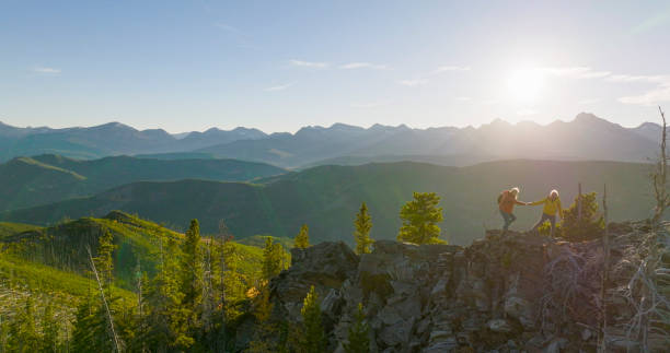istock Senior couple explore mountain top together at sunrise 2152846931