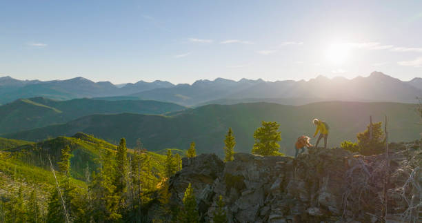 istock Senior couple explore mountain top together at sunrise 2152846933