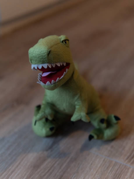 istock Closeup of green dinosaur plush standing, blurred background 2152847237