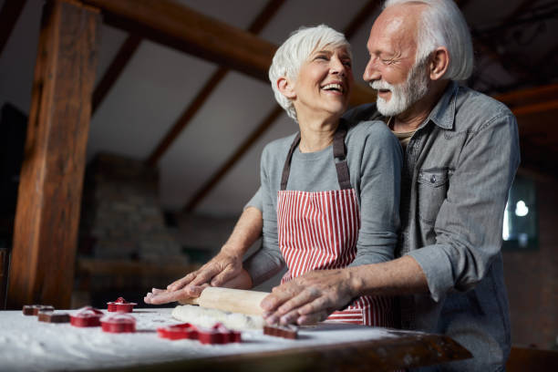 istock Happy senior couple talking while kneading pastry dough in the kitchen. 2152847365