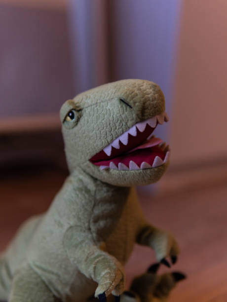 istock Closeup of green dinosaur plush standing, blurred background 2152847398