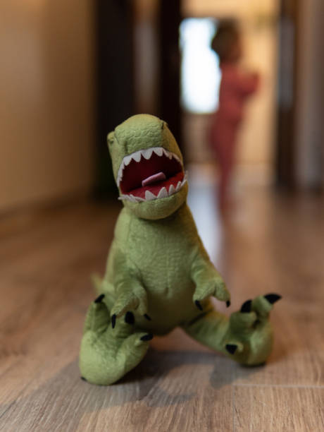 istock Closeup of green dinosaur plush standing, blurred background 2152847496
