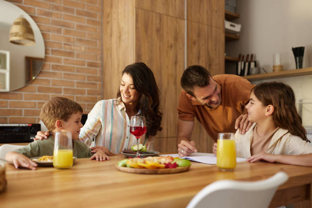istock Young happy family talking during a healthy snack at dining table. 2152848716