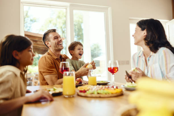 istock Cheerful family talking during a meal at dining table. 2152850017