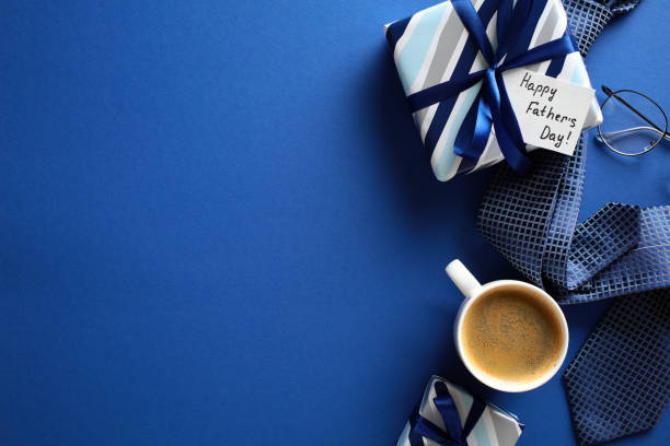istock Festive flat lay composition with coffee, gifts, glasses, and tie on blue backdrop - perfect for Father’s Day promotions and morning vibes 2152850162