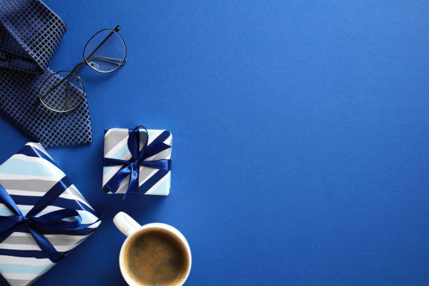 istock Minimalist flat lay with gifts, coffee, tie, glasses on blue backdrop - ideal for celebration Fathers Day theme 2152850287